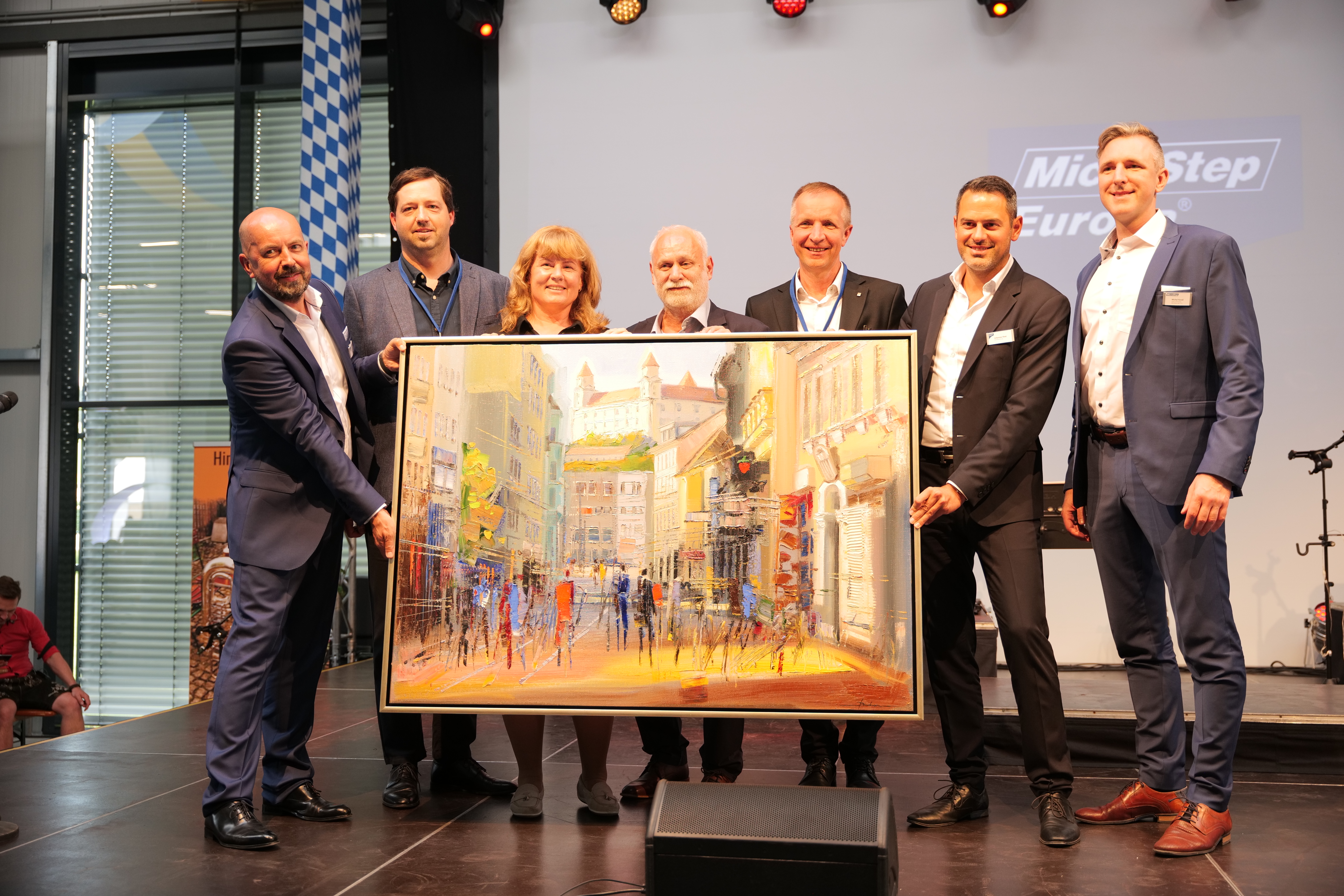 A painting for the new CompetenceCenter: The handover ceremony. From left to right: Managing Director of MicroStep Europa Igor Mikulina, Head of MicroStep Production Plant Peter Bernát, Managing Director of MicroStep Eva Stejskalová, Managing Director of MicroStep Europa Mikuláš Bučinský, Managing Director of MicroStep Alex Makuch, Managing Director of MicroStep Europa Johannes Ried, Head of MicroStep Marketing Michal Kováč